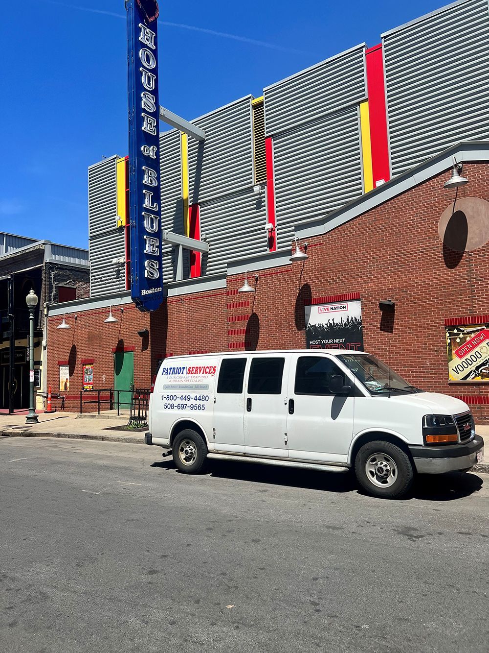 White Patriot Services van parked on street in front of the House of Blues.
